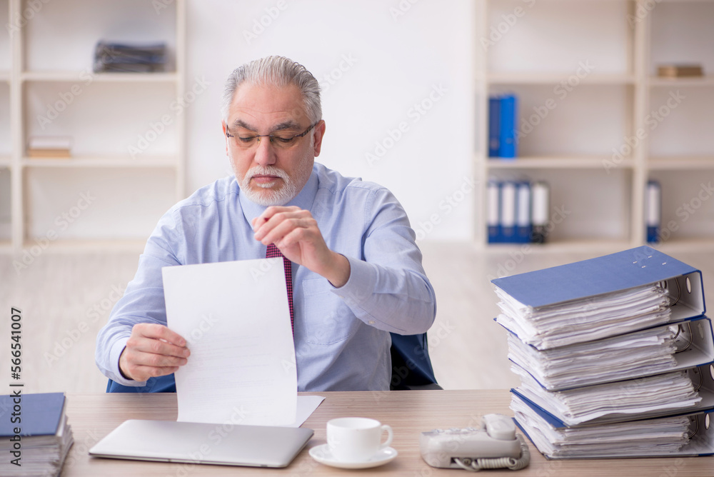Old male employee and too much work at workplace Old male employee and too much work at workplace