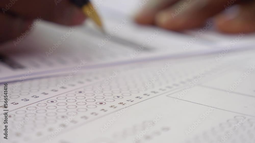 hand of young black man fills out a a multi choice test hand of young black man fills out a a multi choice test