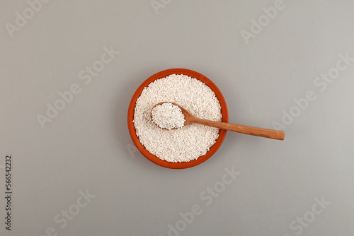 Potassium sorbate, granular potassium salt of sorbic acid in ceramic dish on grey surface. Food additive E202 used as food preservative, prevent mold and microbes and to increase shelf life photo