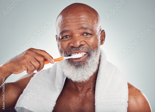 Black man, dental hygiene and toothbrush with wellness, brushing teeth and smile on grey studio background. Oral health, African American male and guy clean mouth, fresh breath and grooming routine