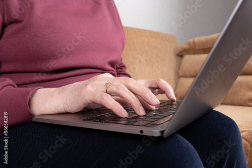 Typing text on keyboard, mature female hands typing text on keyboard. Elderly senior woman using or working on laptop. Old people with technology concept idea. Writing email, communicating online.