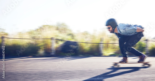 Sports, skateboard and man riding on road for fitness, exercise and wellness. Training, freedom and male skater on board moving with fast speed, skateboarding and skating outdoors for action workout © Jesse B/peopleimages.com