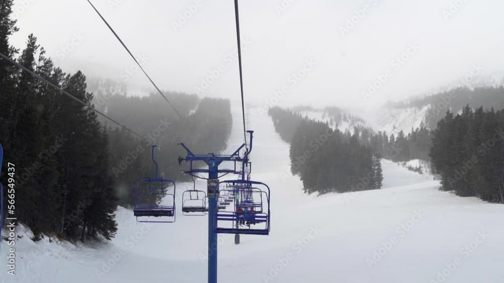 chairlift with skiers and snowboarders at a ski resort in Alberta, Canada chairlift with skiers and snowboarders at a ski resort in Alberta, Canada