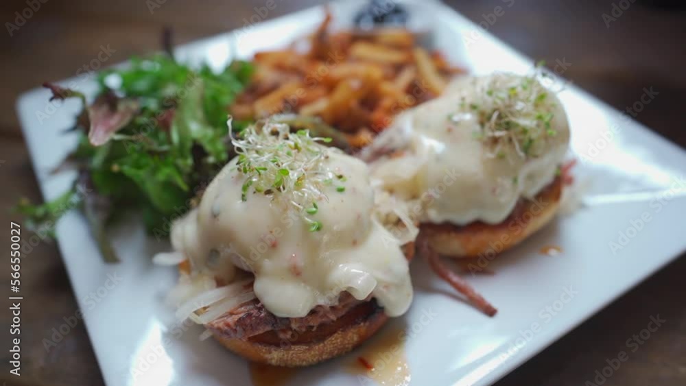 Eggs Benedict breakfast, fries and salad Eggs Benedict breakfast, fries and salad