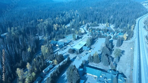 Manning Park aerial birds top view flyover overlooking presort hotel, indoor swimming pool, outdoor tennis courts, rows of chalets sectioned off by trees at mountain valley greens changing color 3-3 photo