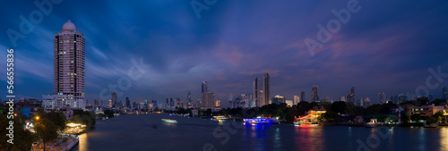 Panoramic Bangkok cityscape. Night view of tall buildings and Chao Phraya river in business district. Nightfall. Bangkok Thailand