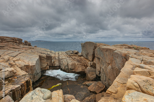 Close up of Natural Bridge a natural phenomenon of boulders and is a tourist attraction in Torndirrup National Park on the South Coast of Western Australia with a view from below to the open sea photo