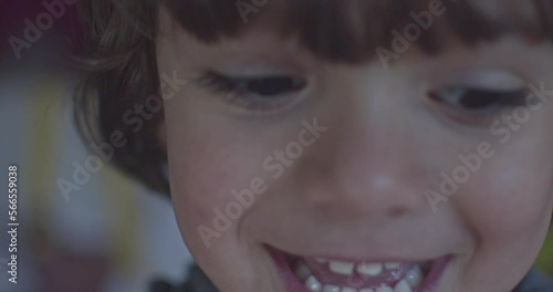 Cinematic close-up of 4-year-old Caucasian boy smiling at 4k camera. Slow Motion.