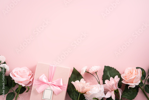 Valentine's Day and Mother's Day design concept background with pink flower and gift on pink background.