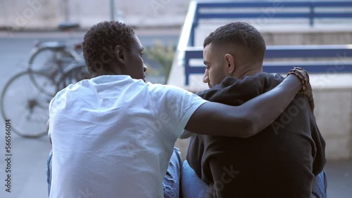 support, solidarity - young african man comforts his despondent friend