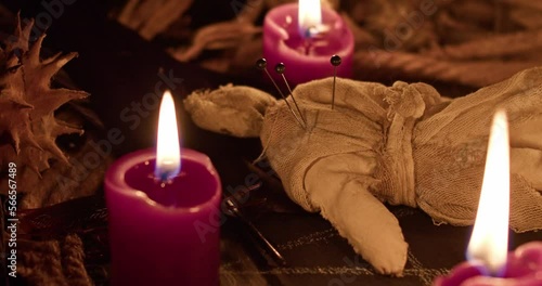 Occultist dripping hot wax on voodoo doll, magic rituals, black spell, horror.