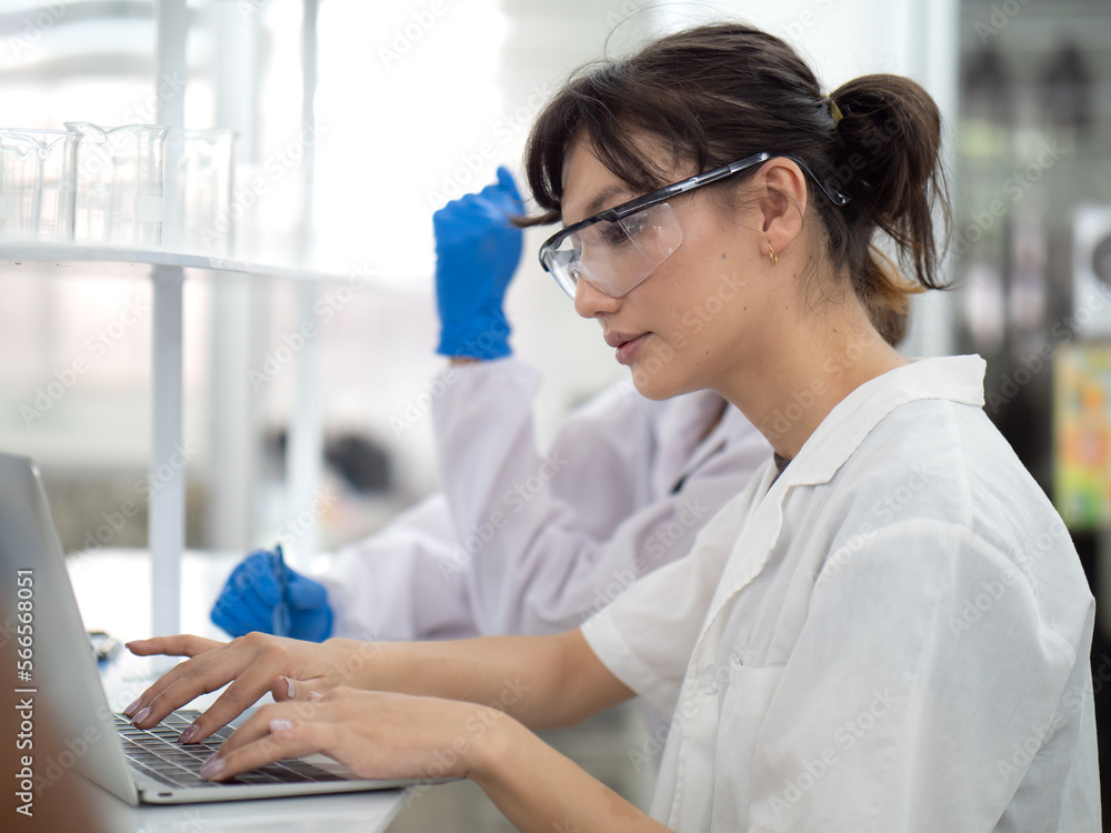 Thoughtful female medical students using laptop computer to research and serious learning in healthcare and medicine. Portrait of young intern doctor woman studying in university with confidence. Thoughtful female medical students using laptop computer to research and serious learning in healthcare and medicine. Portrait of young intern doctor woman studying in university with confidence.