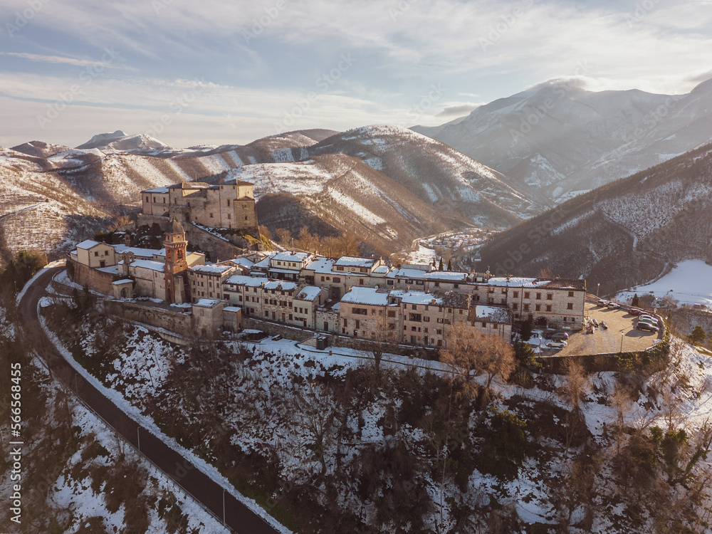Italy, January 2023: aerial view of the medieval village of Frontone covered in snow. The village is located in the Marche region n the province of Pesaro and Urbino