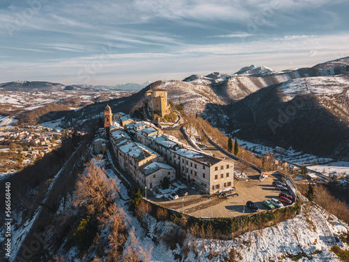 Italy, January 2023: aerial view of the medieval village of Frontone covered in snow. The village is located in the Marche region n the province of Pesaro and Urbino photo