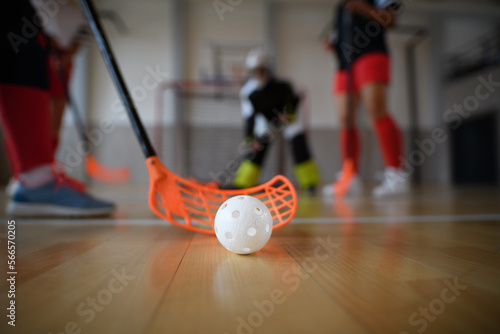 фотографія Close-up of floorball stick and ball during woman floorball match in gym