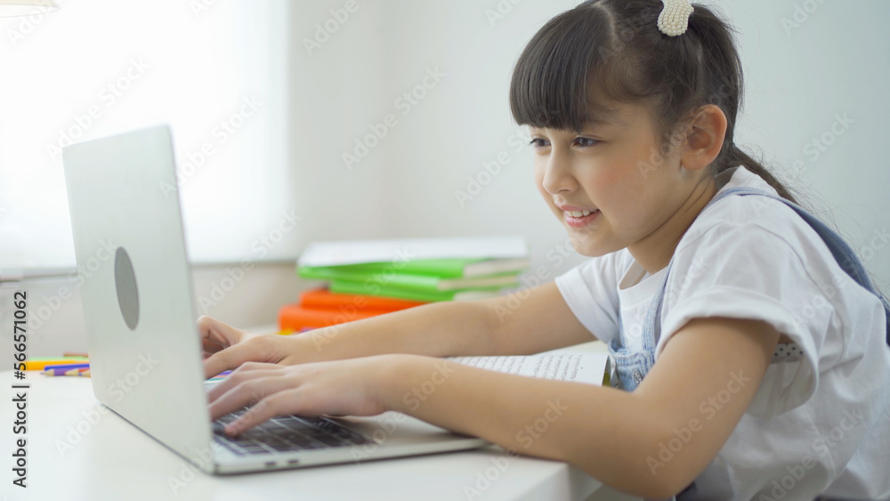 Portrait of happy young smiling child kid girl, Asian Thai woman studying at home with computer laptop notebook device online, people lifestyle. Portrait of happy young smiling child kid girl, Asian Thai woman studying at home with computer laptop notebook device online, people lifestyle.