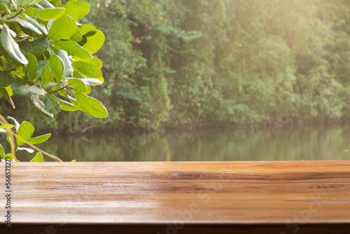 empty wooden table with lake background 