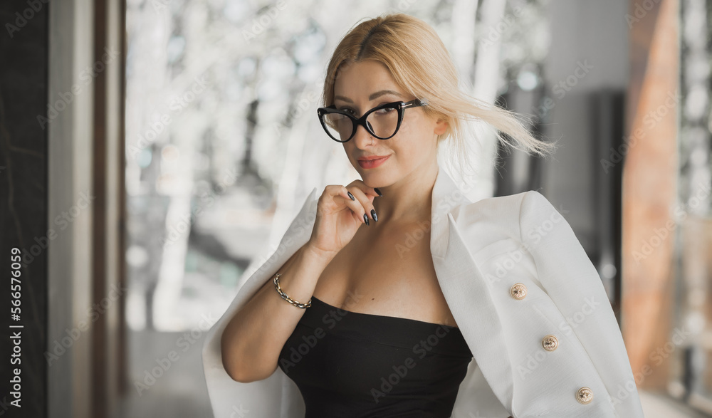Women in business style, portrait. Lady in white jacket and glasses. Outfits and modern classical trend Women in business style, portrait. Lady in white jacket and glasses. Outfits and modern classical trend