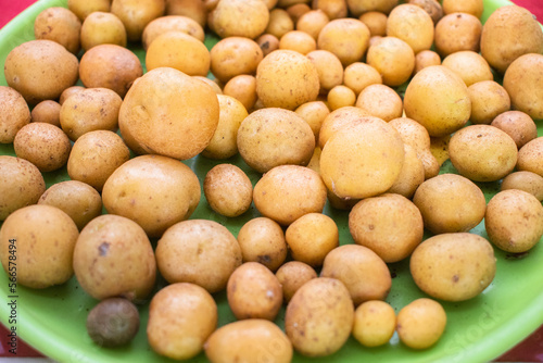Collection of fresh baby potatoes on a plate.