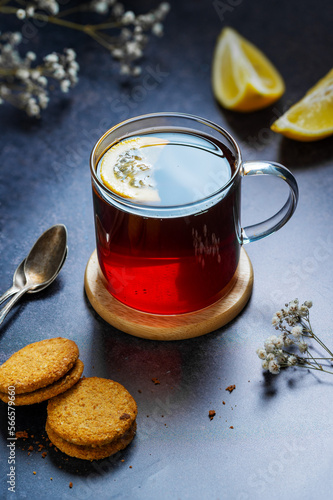 Black tea in glass cup, hot traditional tea with cookies