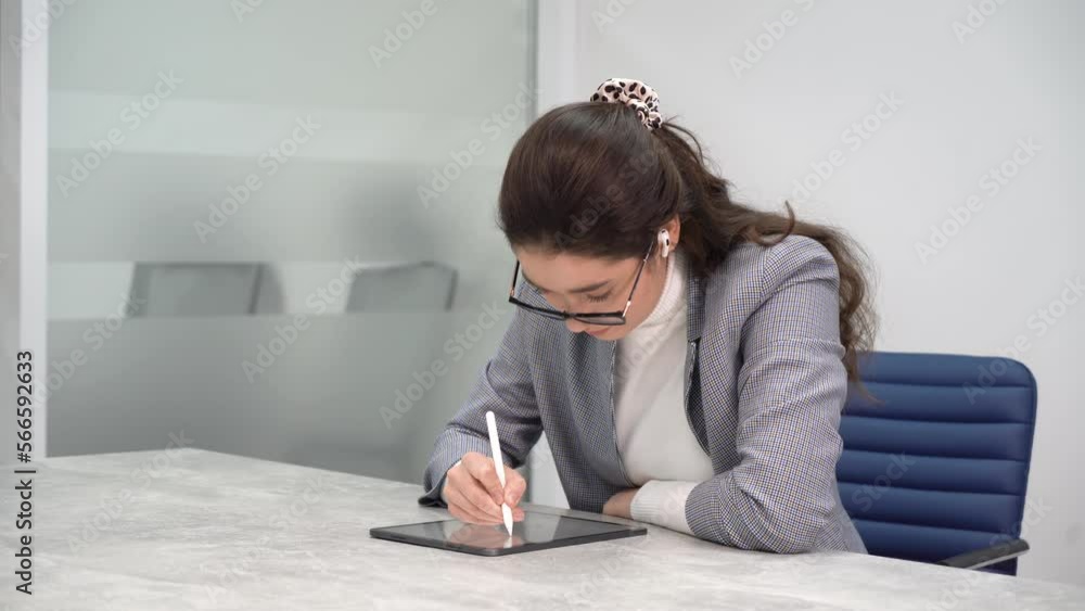 Young business lady busy working at her digital tablet Young business lady busy working at her digital tablet