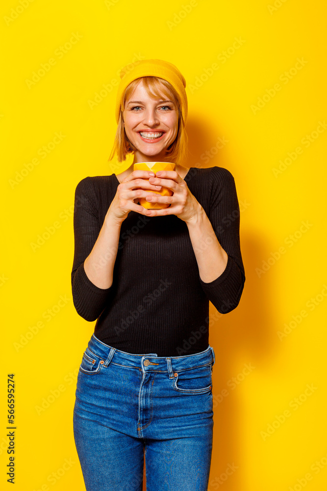Woman drinking coffee on yellow background Woman drinking coffee on yellow background