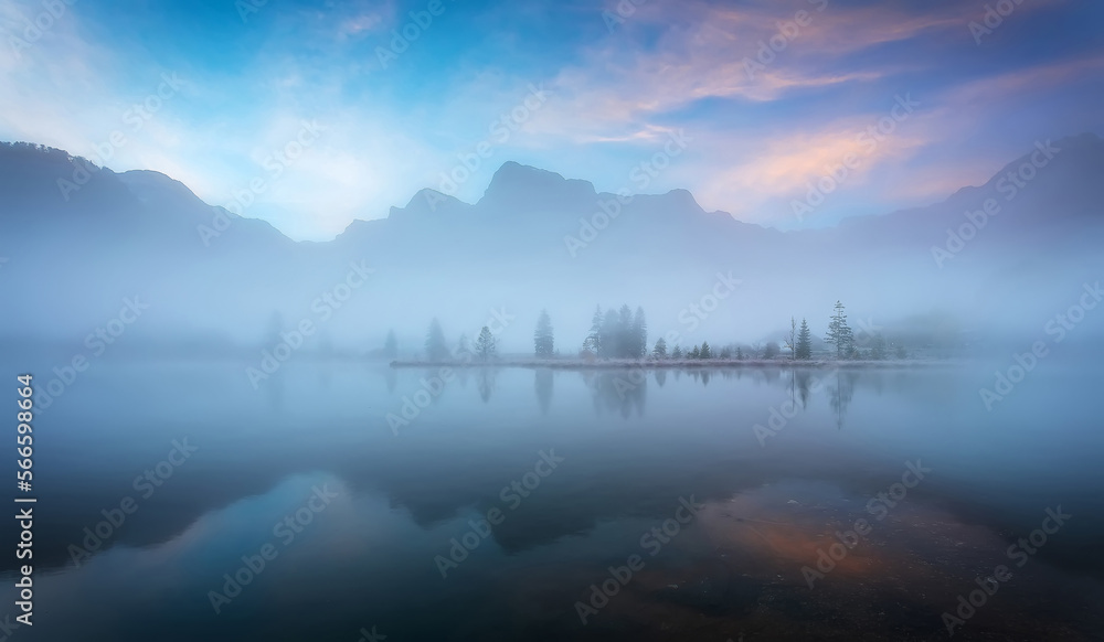 Fabulous misty morning scene of nature. View of Forest lake, Almsee lake in highland with rocky peak on background. Stunning wild nature during sunrise. Amazing natural summer scenery Creative image.
