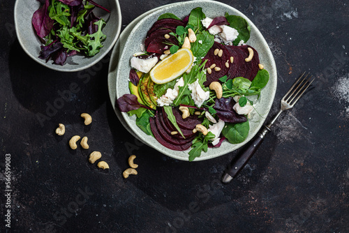 Salad with beets and goat cheese on a dark background