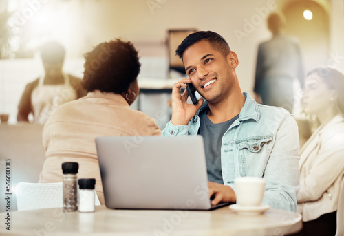 Creative man, phone and laptop at cafe with smile for communication, networking or conversation. Happy male freelancer smiling for call, discussion or startup on smartphone at coffee shop restaurant