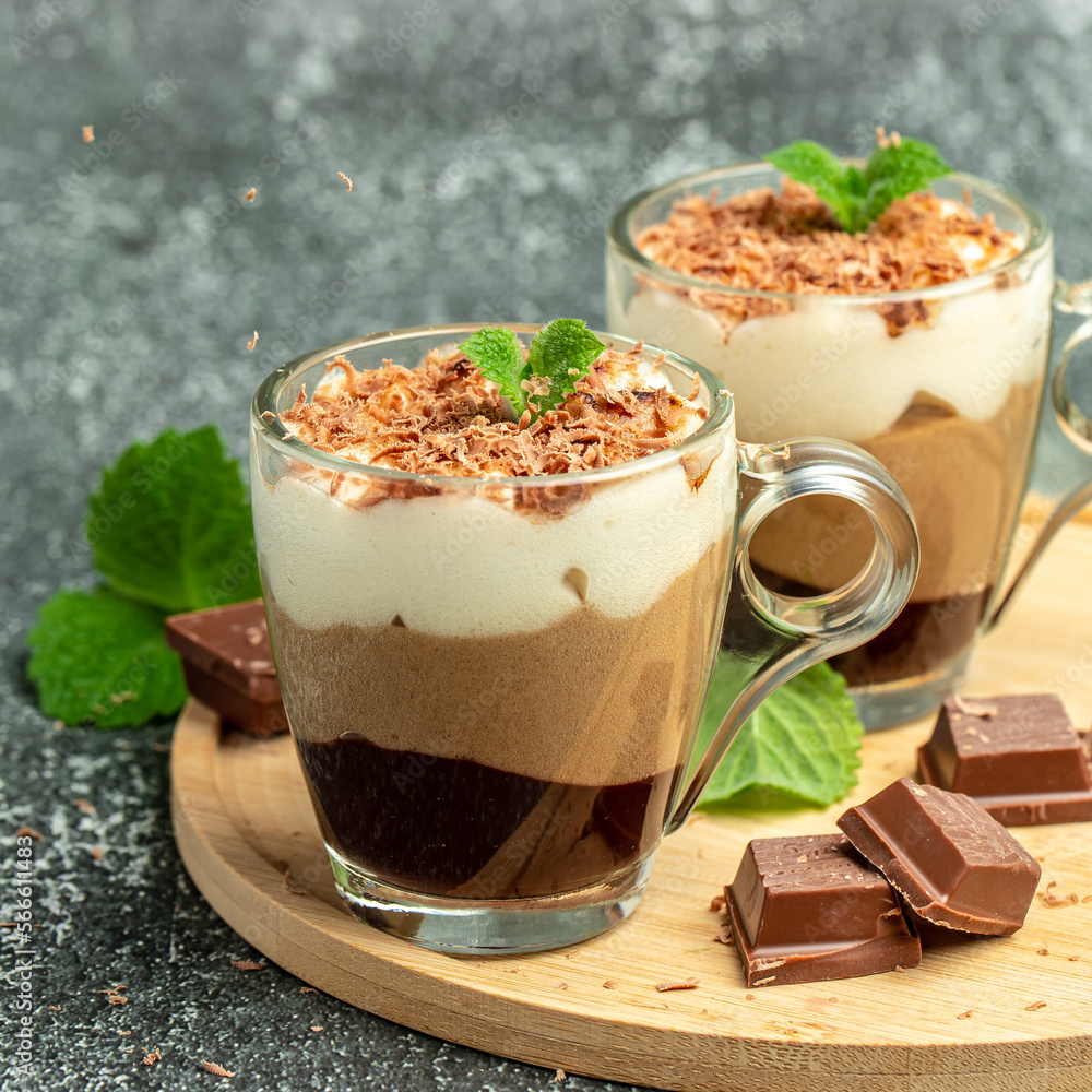 Dessert three chocolate in a glass jar on a wooden board. Food recipe background. Close up Dessert three chocolate in a glass jar on a wooden board. Food recipe background. Close up