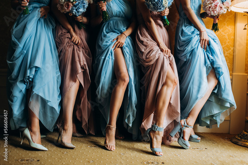 Bridesmaids in colorful dresses with bouquets of flowers. the bride and her friends in colorful dresses