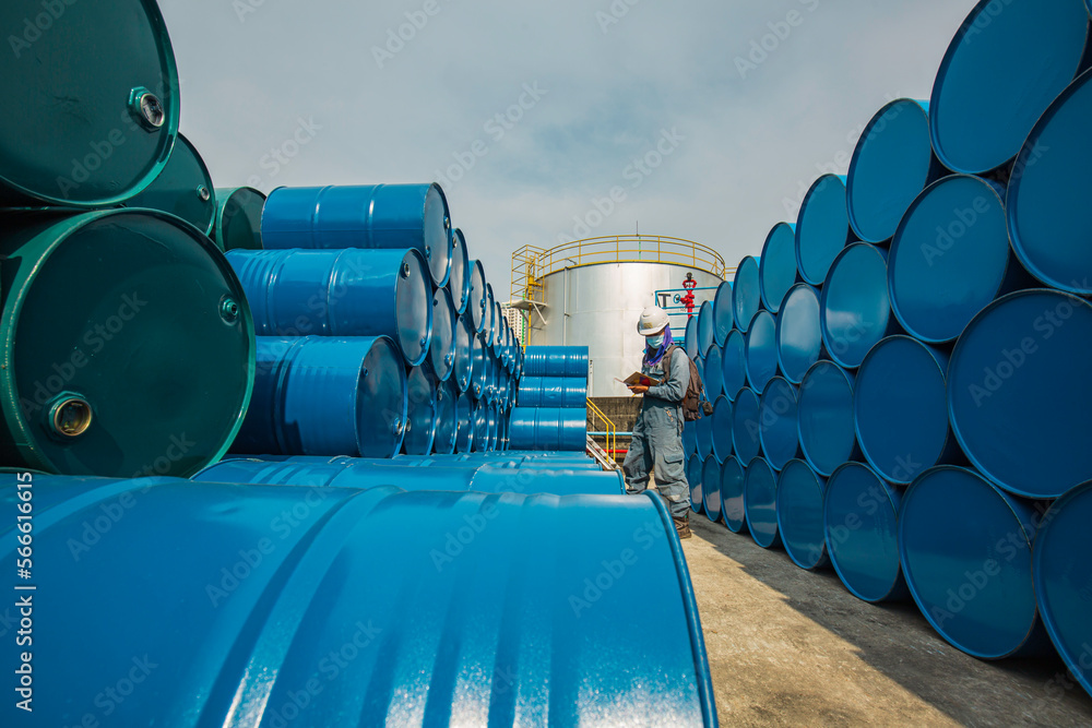 Male worker inspection record drum oil stock barrels blue horizontal or chemical Male worker inspection record drum oil stock barrels blue horizontal or chemical