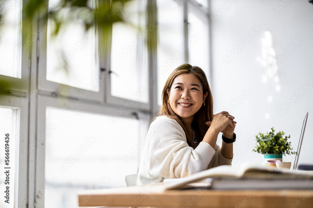 Young female freelancer working in loft office
