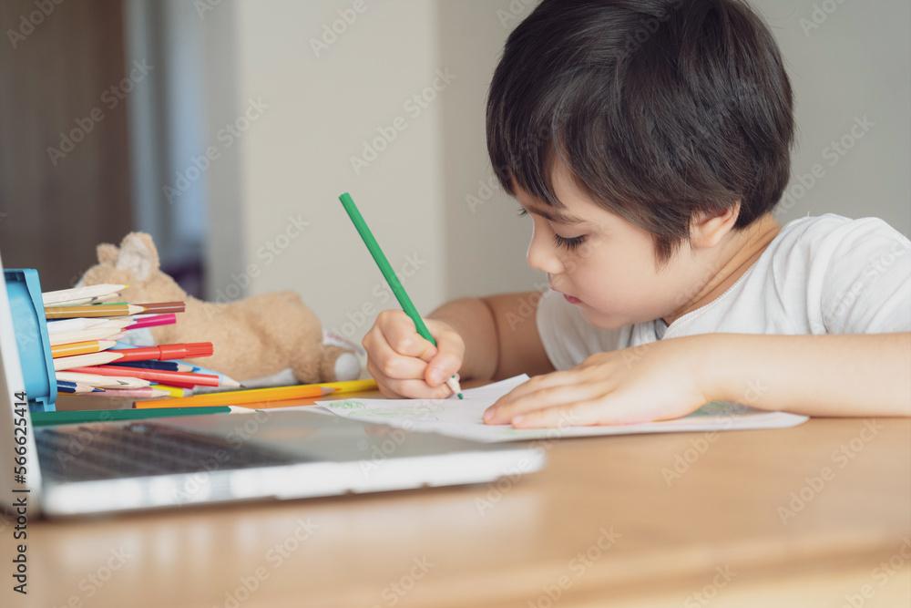 Education concept,School kid using grey colour pen drawing or sketching on paper,Portrait boy siting on table doing homework in living room,Child enjoy art and craft activity at home on weekend Education concept,School kid using grey colour pen drawing or sketching on paper,Portrait boy siting on table doing homework in living room,Child enjoy art and craft activity at home on weekend