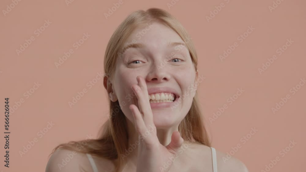 Portrait of 20s beautiful Caucasian female posing and doing silly faces against pastel background Portrait of 20s beautiful Caucasian female posing and doing silly faces against pastel background