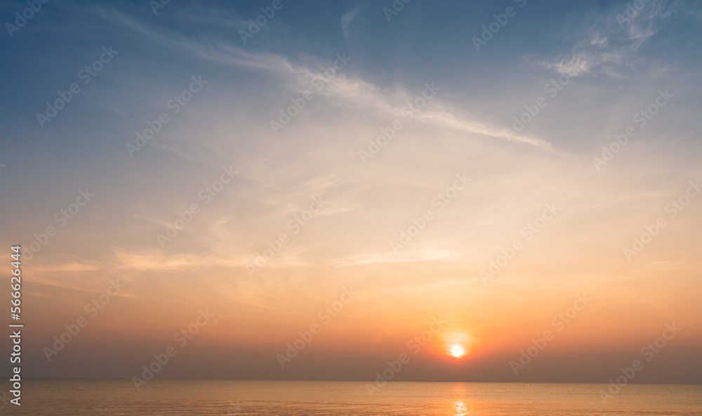 Sunset sky clouds over horizon sea in the morning with orange, red, yellow sunrise golden hour and blue background 