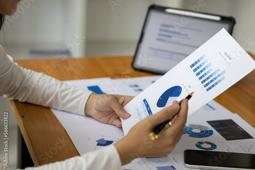 Accountant working on consolidated financial report of corporate operations, consultant auditing finance data (balance sheet, income statement) on laptop with business charts, fintech.