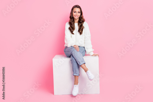 Full length photo of adorable pretty lady wear white sweater having rest podium smiling isolated pink color background
