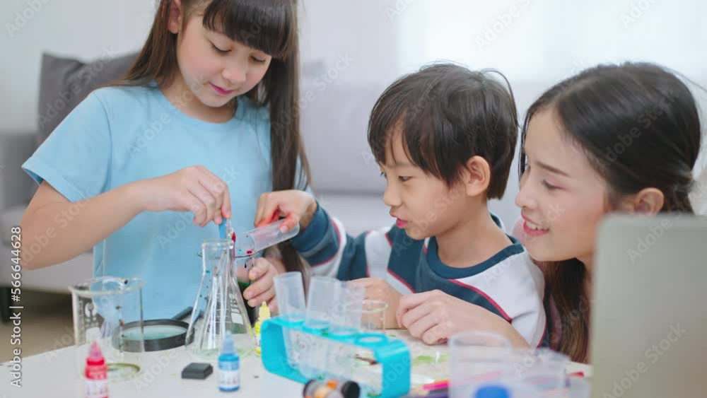 Education and Child and science concept.Cute elementary school boy and girl looking into microscope at home.Parent mother with daughter kid and son scientist making experiments in his home laboratory. Education and Child and science concept.Cute elementary school boy and girl looking into microscope at home.Parent mother with daughter kid and son scientist making experiments in his home laboratory.