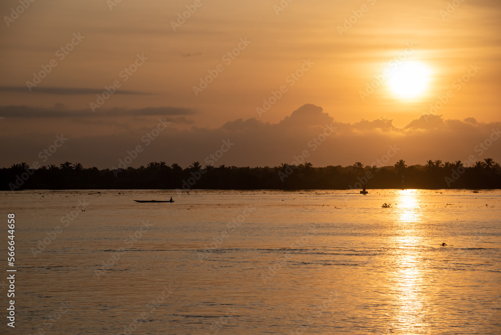 Small fisherman's boat navigating the Magdalena River at dawn. Colombia.