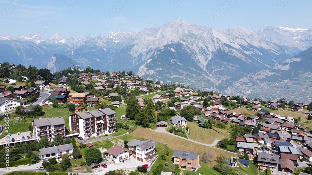 Swiss Alps in Sion region, aerial footage taken by a drone during warm summer time, clear blue skies and beautiful mountain scenery