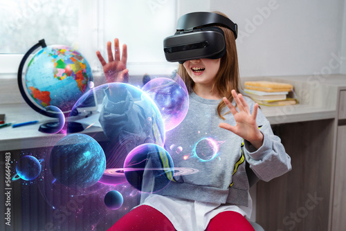 Child girl wearing virtual reality headset and looking at digital space system with planets or Universes. Future learning and education