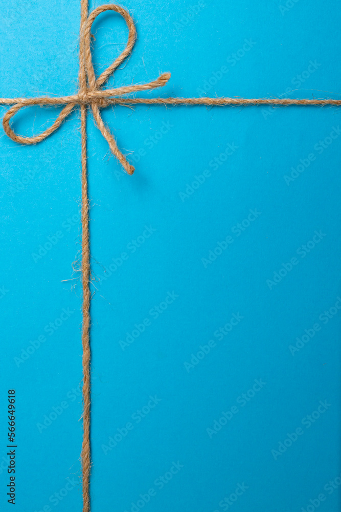 Jute string bow and framing lines on blue paper texture Stock Photo