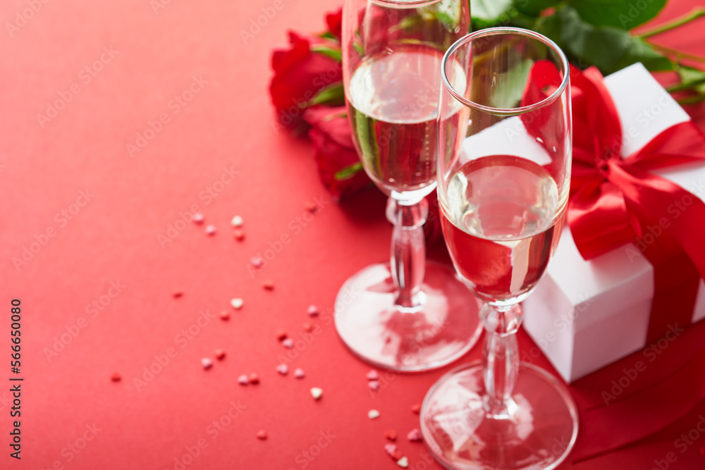 Valentines Day or Romantic dinner concept. Romantic table setting, silverware, wine glasses, gift box, roses and symbol of love red heart on red background. Romantic Dinner Valentines Day concept. Valentines Day or Romantic dinner concept. Romantic table setting, silverware, wine glasses, gift box, roses and symbol of love red heart on red background. Romantic Dinner Valentines Day concept.