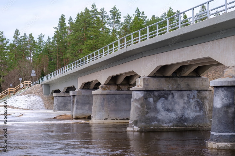 Restored, reconstructed concrete bridge over the longest river in Latvia, Gauja near the city of Strenci. Bridge over the river, spring.