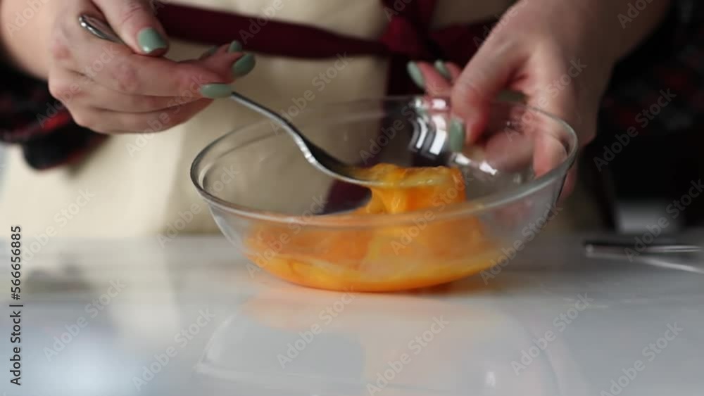 Woman's hands mixing two eggs in transparent plate. Slow motion Woman's hands mixing two eggs in transparent plate. Slow motion