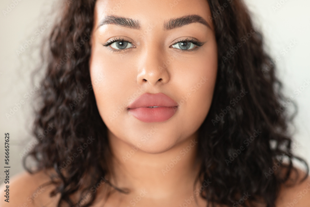 Closeup portrait of beautiful african american body positive woman with perfect smoothy skin, looking at camera Closeup portrait of beautiful african american body positive woman with perfect smoothy skin, looking at camera