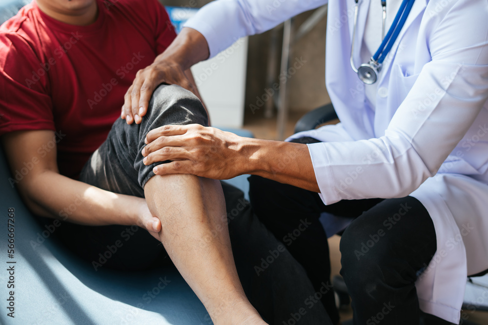 Physiotherapist massaging old man leg,man lying while a physiotherapist folded her leg on her chest.