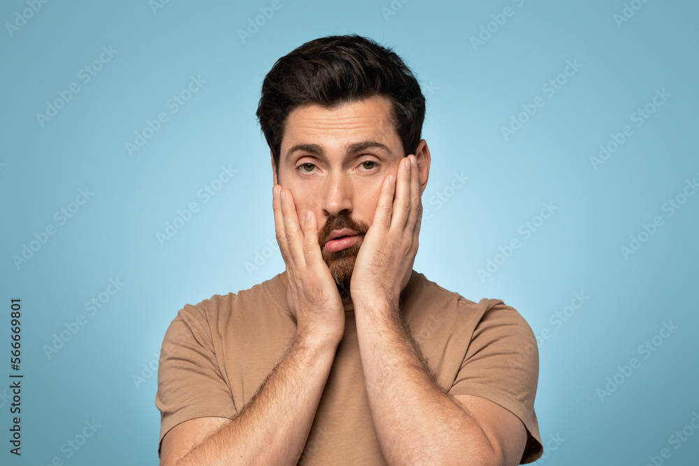 Handsome caucasian man looking sleepy and tired, exhausted for fatigue and hangover, standing over blue background Handsome caucasian man looking sleepy and tired, exhausted for fatigue and hangover, standing over blue background