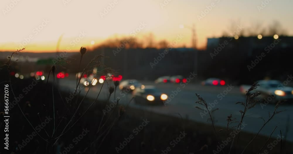 Freeway with lots of cars blurred focus cars. Car traffic on the highway out of focus at sunset. Abstract bright blurred colored bokeh. Bokeh lights in the city night background Freeway with lots of cars blurred focus cars. Car traffic on the highway out of focus at sunset. Abstract bright blurred colored bokeh. Bokeh lights in the city night background